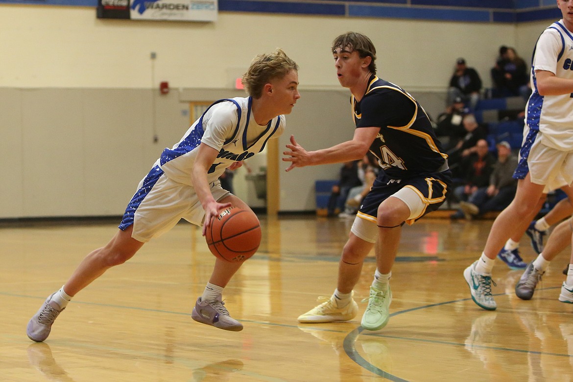 Warden junior Eli Cox, in white, drives past a Naches Valley defender during the second half of Thursday’s game against the Rangers. Cox scored 14 points in the game.