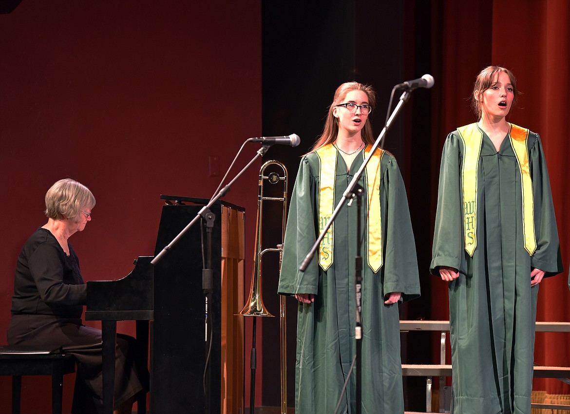 Alma Ramlow on piano and students Nora Ide and Cassidy Krack at the Whitefish High School choir winter concert. (Kelsey Evans/Whitefish Pilot)