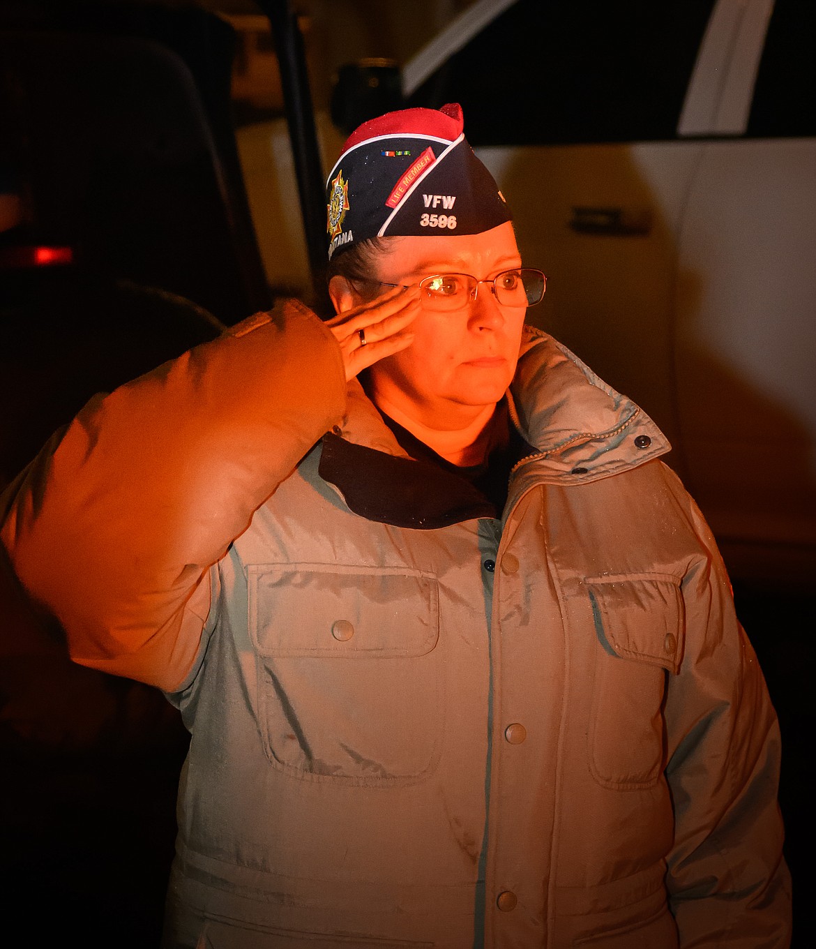 Veteran Heather Allen honors the American flag with a salute. (Tracy Scott/Valley Press)