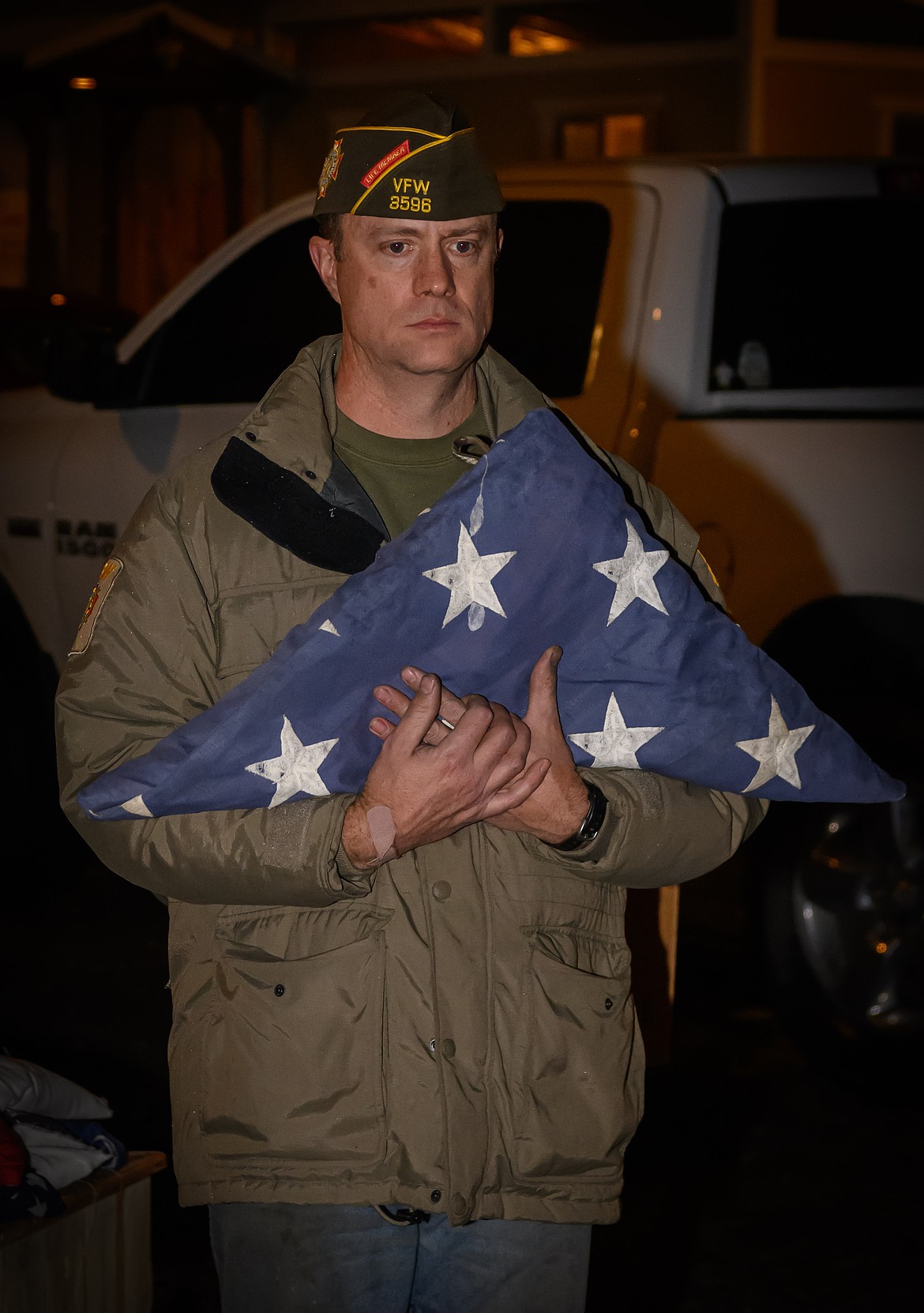 Noah Hathorne, a member of the Plains VFW Post, prepares to dispose of an American flag. (Tracy Scott/Valley Press)