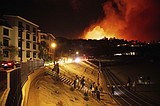 Homes burn as wind-driven wildfire prompts evacuations in Malibu, California