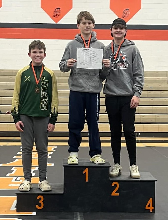 Bonners Ferry's Warren Hummel (middle) and Brody Swift (right) are all smiles after placing first and second in the 137-pound bracket at the District 1 Middle School Wrestling Championship held Saturday at Priest River High.