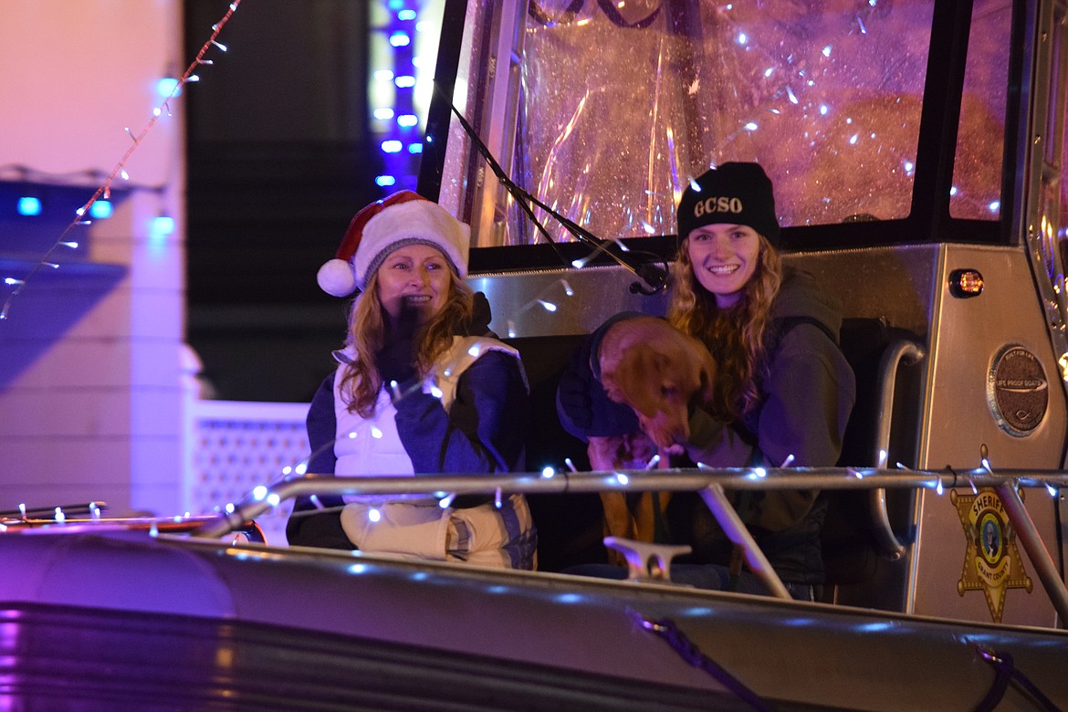 Participants in the Bells on Basin parade in Ephrata wave from the Grant County Sheriff’s Office patrol boat during the 2013 holiday season. The sheriff’s office is currently collecting donations for its annual Shop with a Cop event through Dec. 15. GCSO partners with the Moses Lake Police Department each year to bring joy to local children.