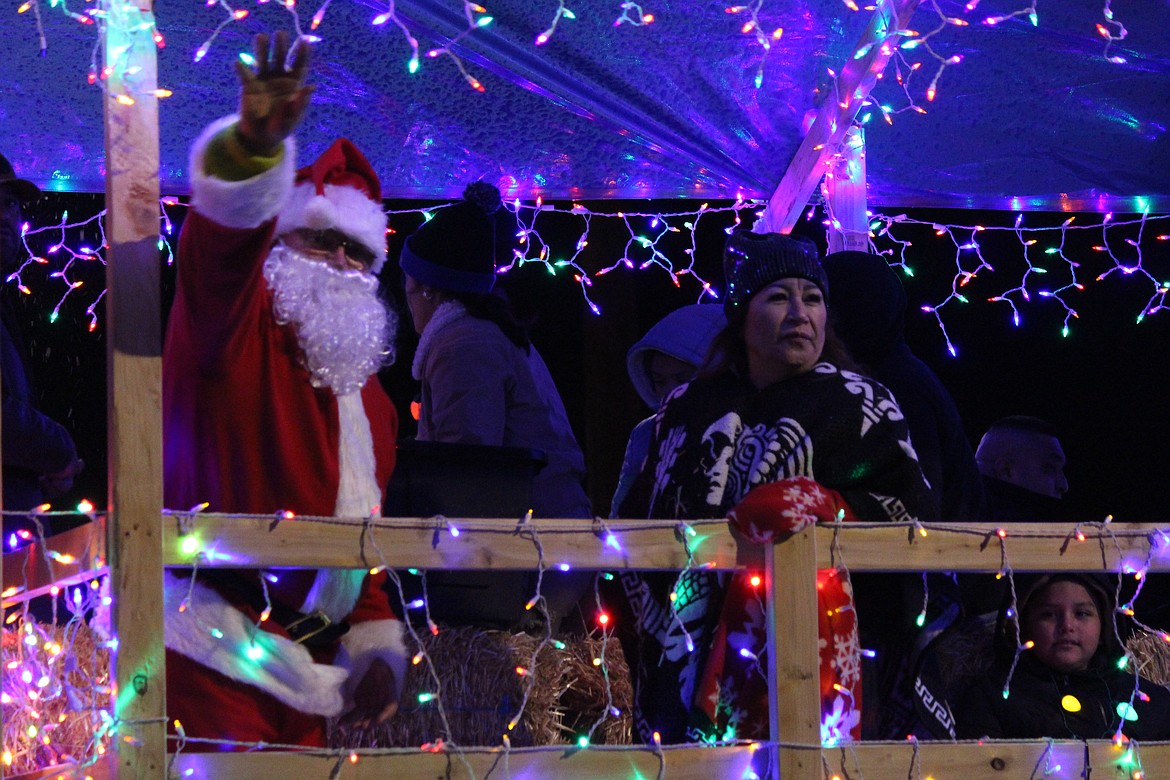 Santa waves to the crowd from an Othello Christmas parade float.