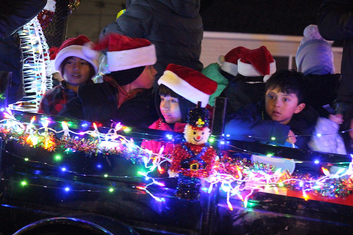 Children ride on a float in the Othello Christmas parade Dec. 6.