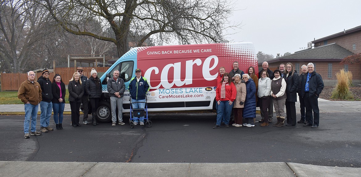 Members of the Kiwanis Club of Moses Lake, the Rotary Club of Moses Lake and Care Moses Lake gather for a photo in front of Care Moses Lake’s new transport van, which the organization recently received through donations  from the two clubs and the Paul Lauzier Foundation.