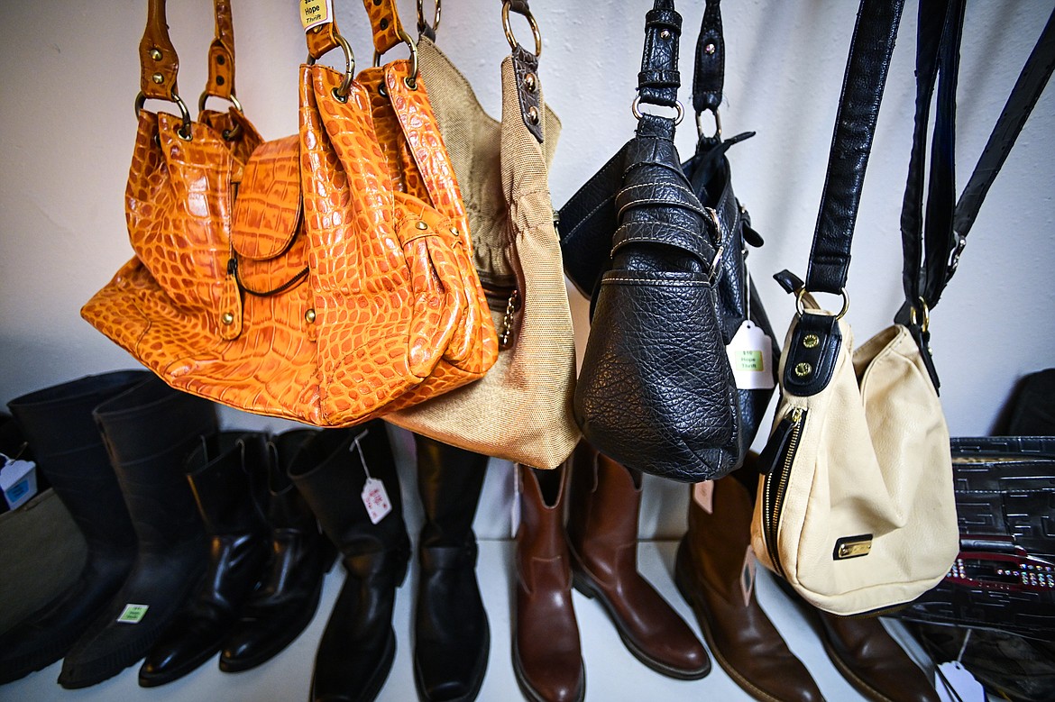 An assortment of handbags and boots on display at Hope Thrift in Kalispell on Wednesday, Dec. 11. (Casey Kreider/Daily Inter Lake)