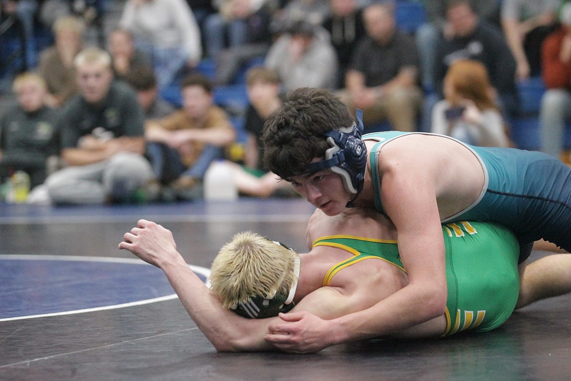 JASON ELLIOTT/Press
Lake City's Connor Johnson holds off Lakeland's Justin Baxter in their match at 132 pounds during a dual between the schools at Coeur d'Alene High on Wednesday. Johnson won by a 12-6 decision.