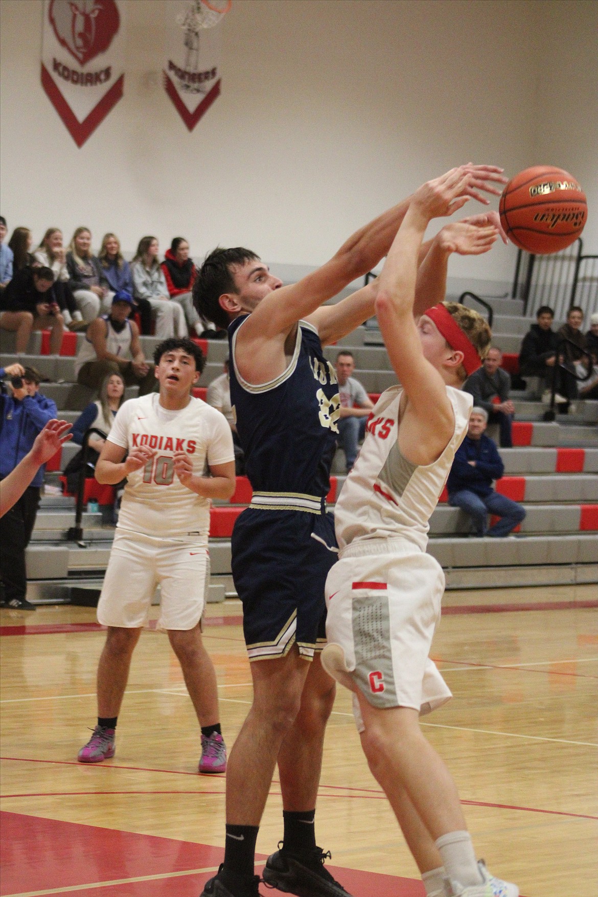 MLCA/CCS junior Dennis Gulenko, in blue, knocks the ball loose during Monday’s game at Cascade (Leavenworth).