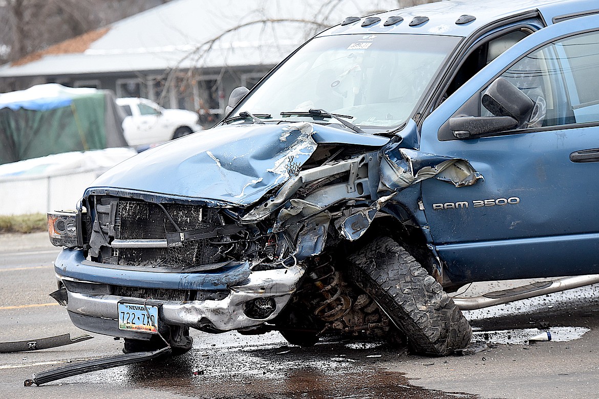 A blue Dodge Ram pickup truck had heavy front-end damage following a collision Thursday morning on U.S. 2 in front of the Dollar General store in Libby. A person in the truck was taken by Libby Volunteer Ambulance to Cabinet Peaks Medical Center for treatment. (Scott Shindledecker/The Western News)
