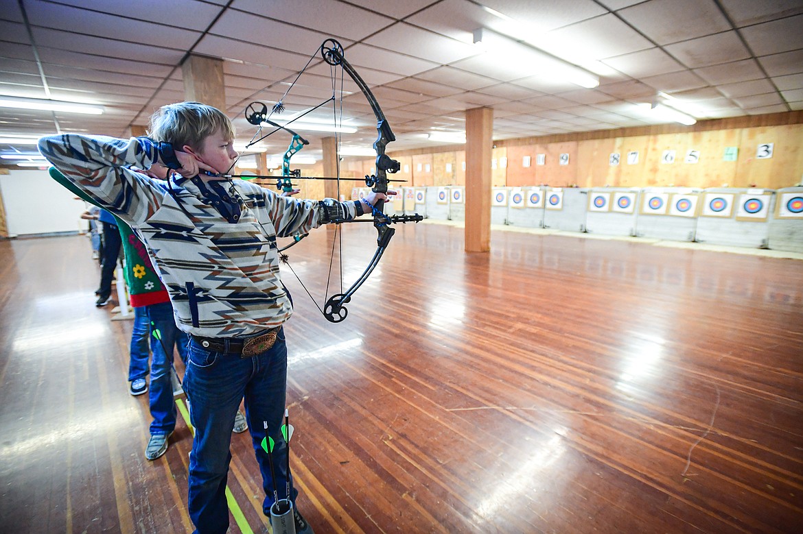 Colton Oedekoven readies an arrow during a round of archery practice with Flathead 4-H Shooting Sports on Thursday, Dec. 12. (Casey Kreider/Daily Inter Lake)