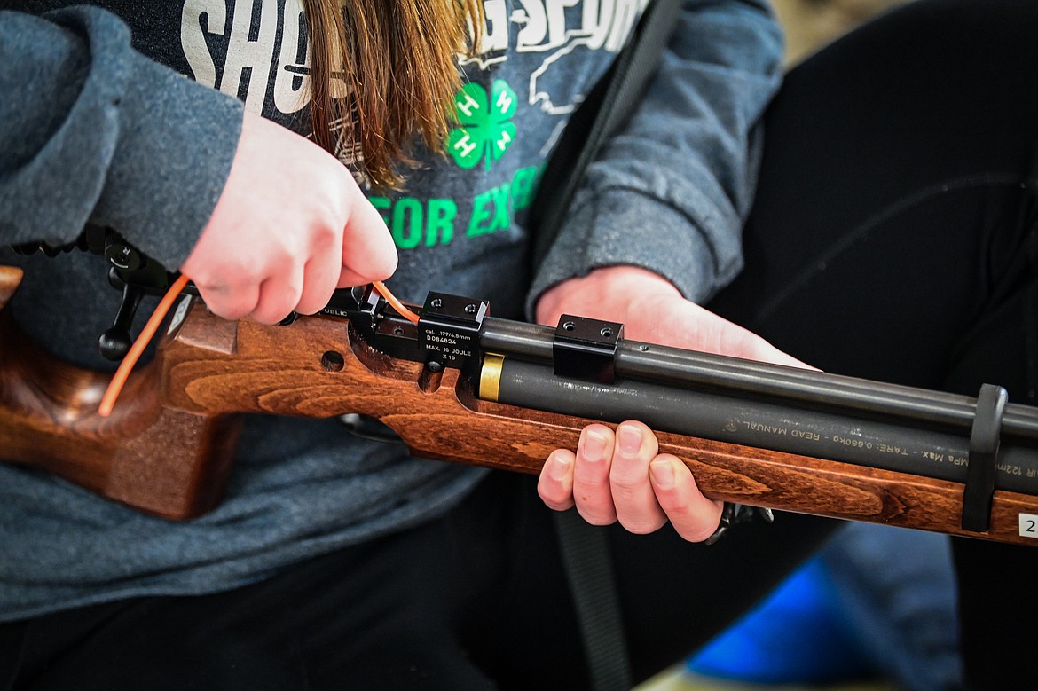 Adelyn Blade cleans the barrel of her air rifle between practice rounds with Flathead 4-H Shooting Sports on Thursday, Dec. 12. (Casey Kreider/Daily Inter Lake)