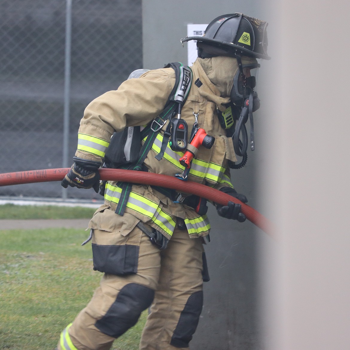 A Coeur d'Alene firefighter enters the old Bonsai Bistro building for training in Coeur d'Alene on Friday.