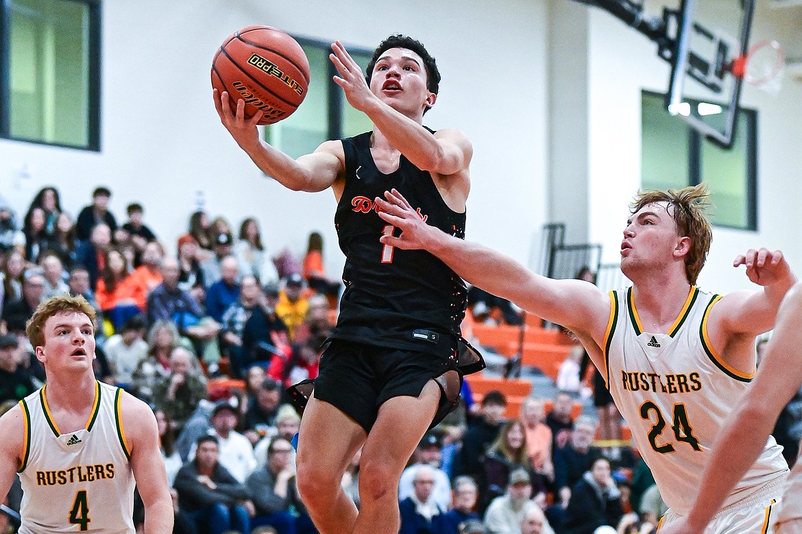 Flathead's Dustyn Franchini-White (1) drives to the basket in the second quarter against Great Falls CMR inside Gene Boyle Gymnasium at Flathead High School on Saturday, Dec. 14. (Casey Kreider/Daily Inter Lake)