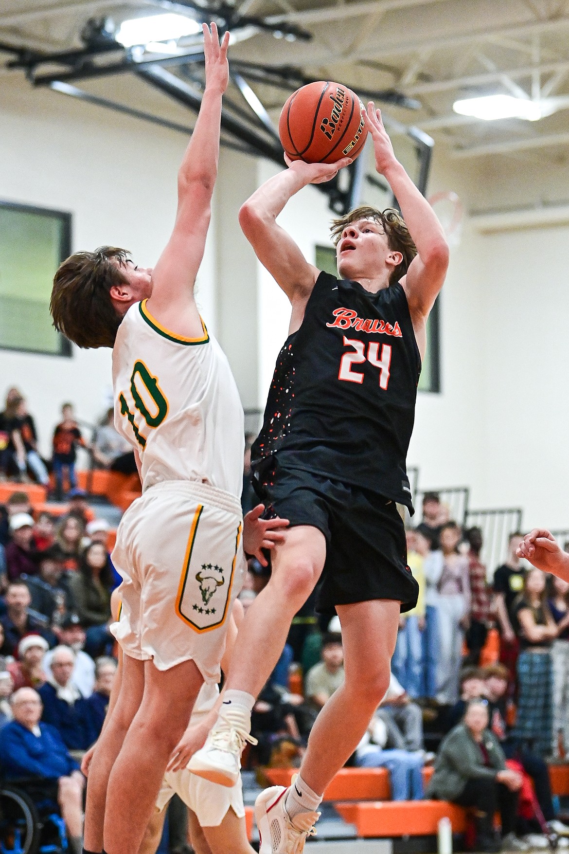 Flathead's Brodee Zahn (24) shoots a jumper in the paint guarded by Great Falls CMR's Brady Henzel (10) in the first quarter inside Gene Boyle Gymnasium at Flathead High School on Saturday, Dec. 14. (Casey Kreider/Daily Inter Lake)