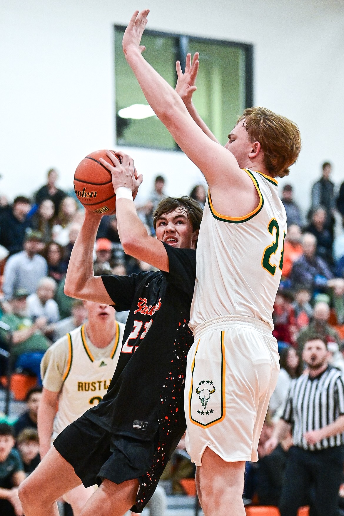 Flathead's Noah Sonju (23) works under the basket against Great Falls CMR's Dean Blair (24) in the first quarter inside Gene Boyle Gymnasium at Flathead High School on Saturday, Dec. 14. (Casey Kreider/Daily Inter Lake)