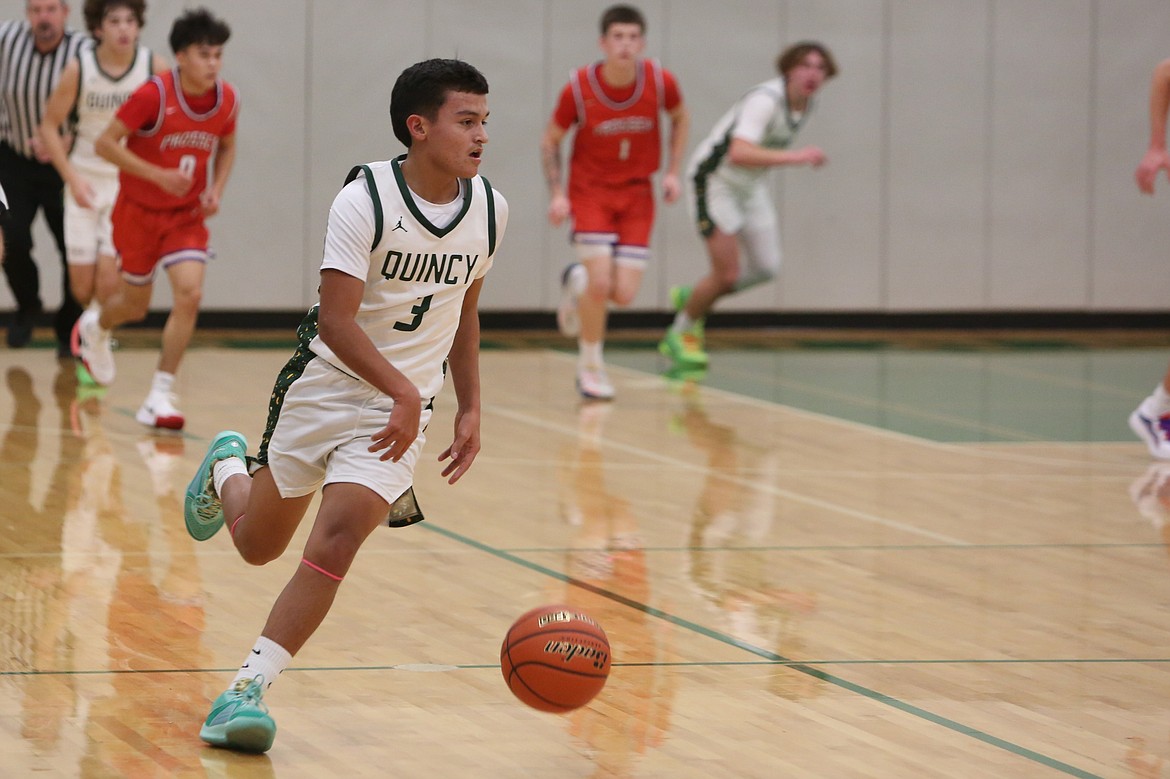 Quincy junior Erick Zepeda (3) brings the ball up the floor during the second quarter against Prosser on Friday.