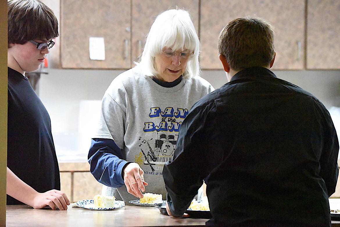 Libby Middle High School band volunteer Patty Johnson helps with distributing desserts at a concert Dec. 17, 2024, at the Memorial Center. (Scott Shindledecker/The Western News)