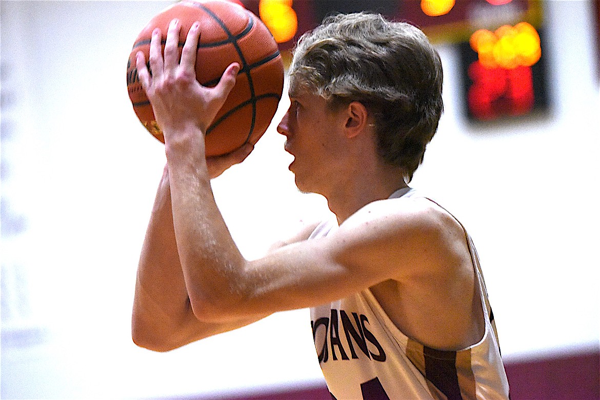 Troy's Cody Todd lines up a shot against the Plains Horsemen in a 49-33 win Saturday, Dec. 14, 2024, at the Troy Activity Center. (Scott Shindledecker/The Western News)