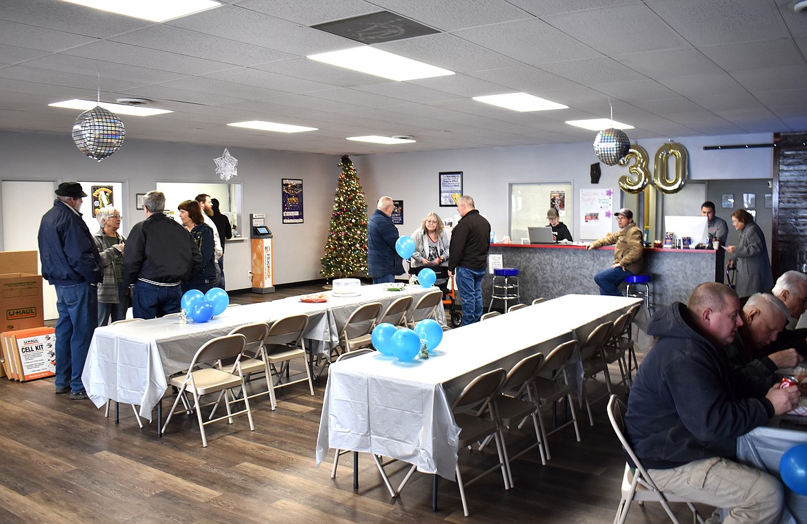 Customers past and present visit and reminisce at Scotty’s Auto Repair’s 30th birthday celebration Friday.