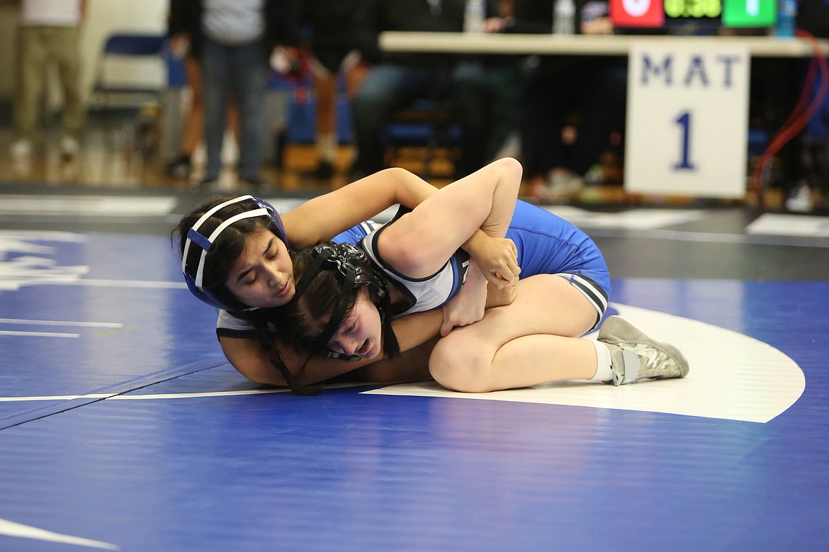 Warden freshman Madilyn Borrego, left, wrestles against a fellow teammate in freshman Maddox Williams, right, at Saturday’s Warden Women’s Wrestling Invite. Borrego took fifth in the 110-pound class while Williams took third.