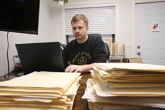 Licensed agent Madison Miles is seen at his desk Dec. 13 in the Miles Insurance Team office in Coeur d'Alene.