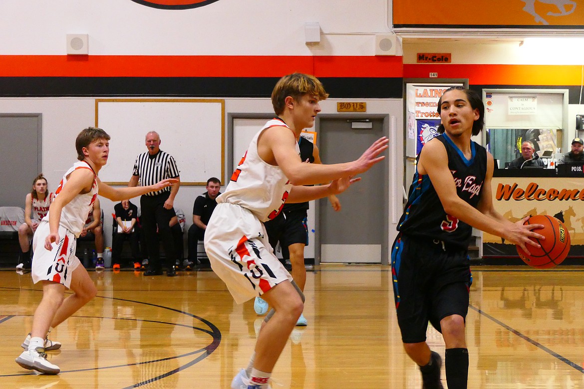 Plains senior Zayden Allen applies defensive pressure to a Two Eagle River player during their game Friday night in Plains.  (Chuck Bandel/VP-MI)