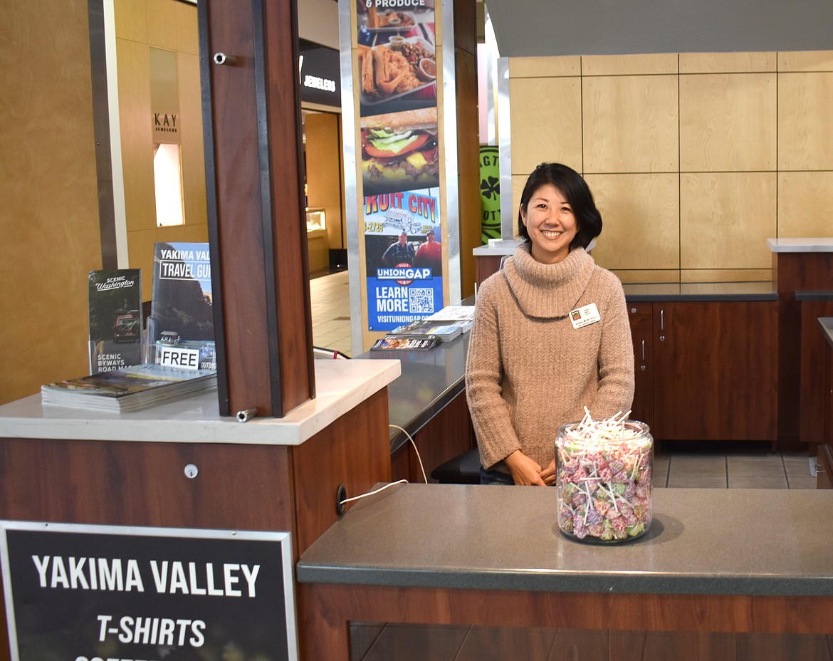 Adina Mori-Holt staffs the Yakima Valley Tourism kiosk at Valley Mall. Because the kiosk is located at the front entrance of the mall, Mori-Holt said, she’s often mistaken for a mall employee and asked for directions.