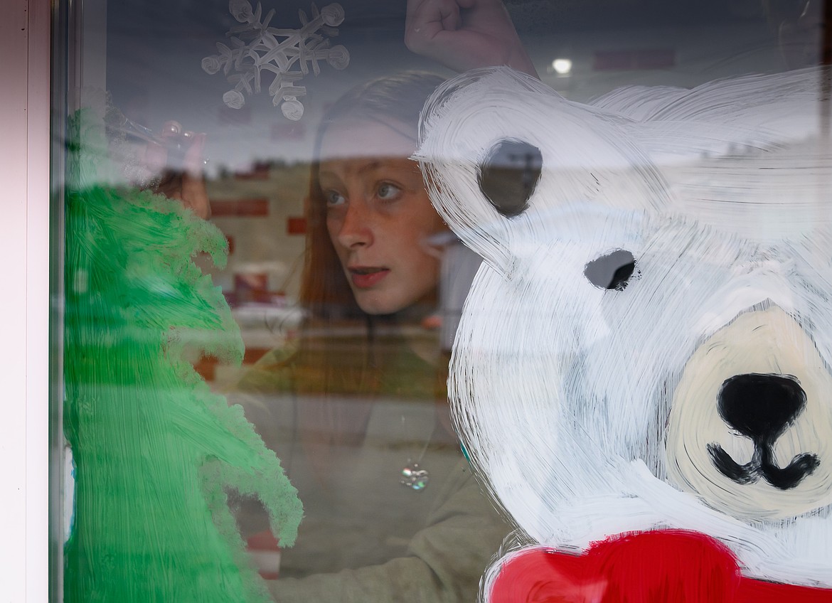 Freshman LeAnna Demarss works on a Christmas tree painting at the Plains Circle restaurant. (Tracy Scott/Valley Press)