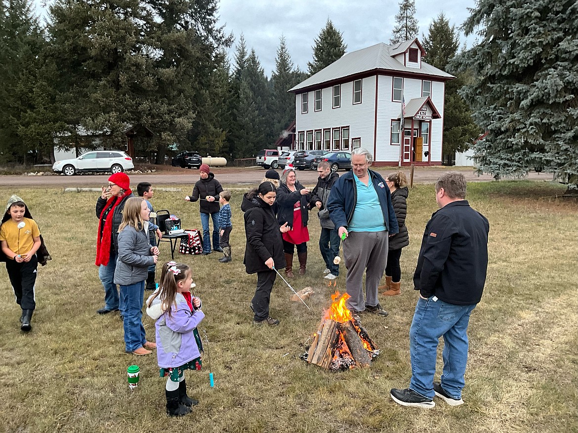 The DeBorgia School hosted the annual Christmas tree lighting Thursday with Santa, refreshments, roasting marshmallows, singing Christmas carols, and fellowship. No snow this year, but enthusiasm and plenty of Christmas spirit was evident. (Bruce Charles photos)