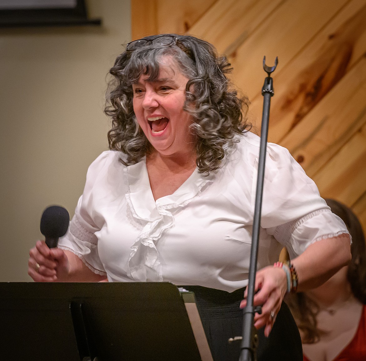 Jeanine Croft directs the audience during their participation with the song "12 Days of Christmas." (Tracy Scott/Valley Press)