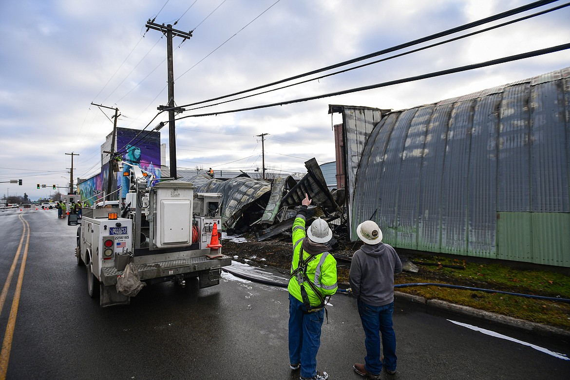 A utility crew at the scene of an early-morning fire in a commercial structure along West Center Street in Kalispell on Tuesday, Dec. 17. (Casey Kreider/Daily Inter Lake)