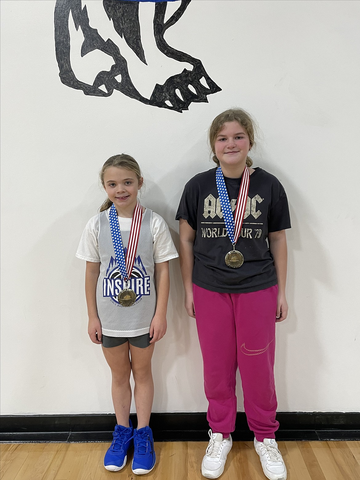 From left Ashlynn Arthur (winner of 8-9 age group) and Zoey Wolf (winner of 10-11 age group) show off their ribbons after a successful Elk's Hoop Shoot.