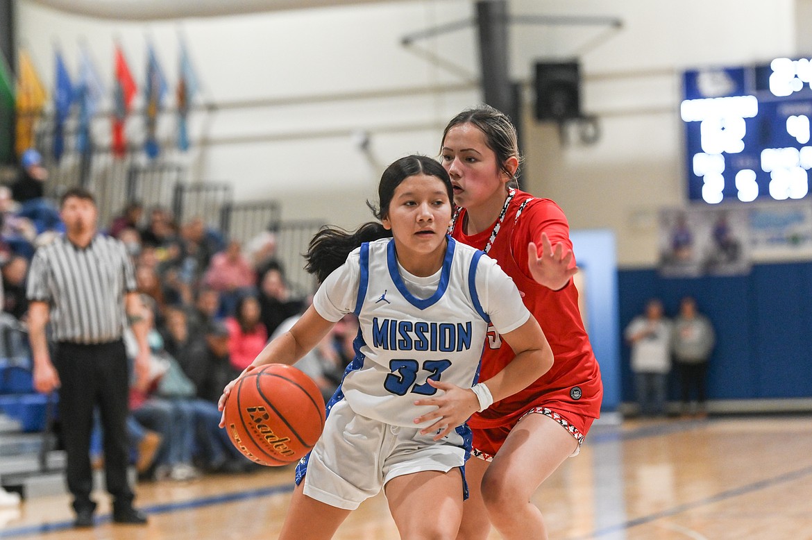 Scarlet Malia Standing Rock guards Lady Bulldog Mary Lamere during last week's game between the two Lake County rivals. (Christa Umphrey photo)