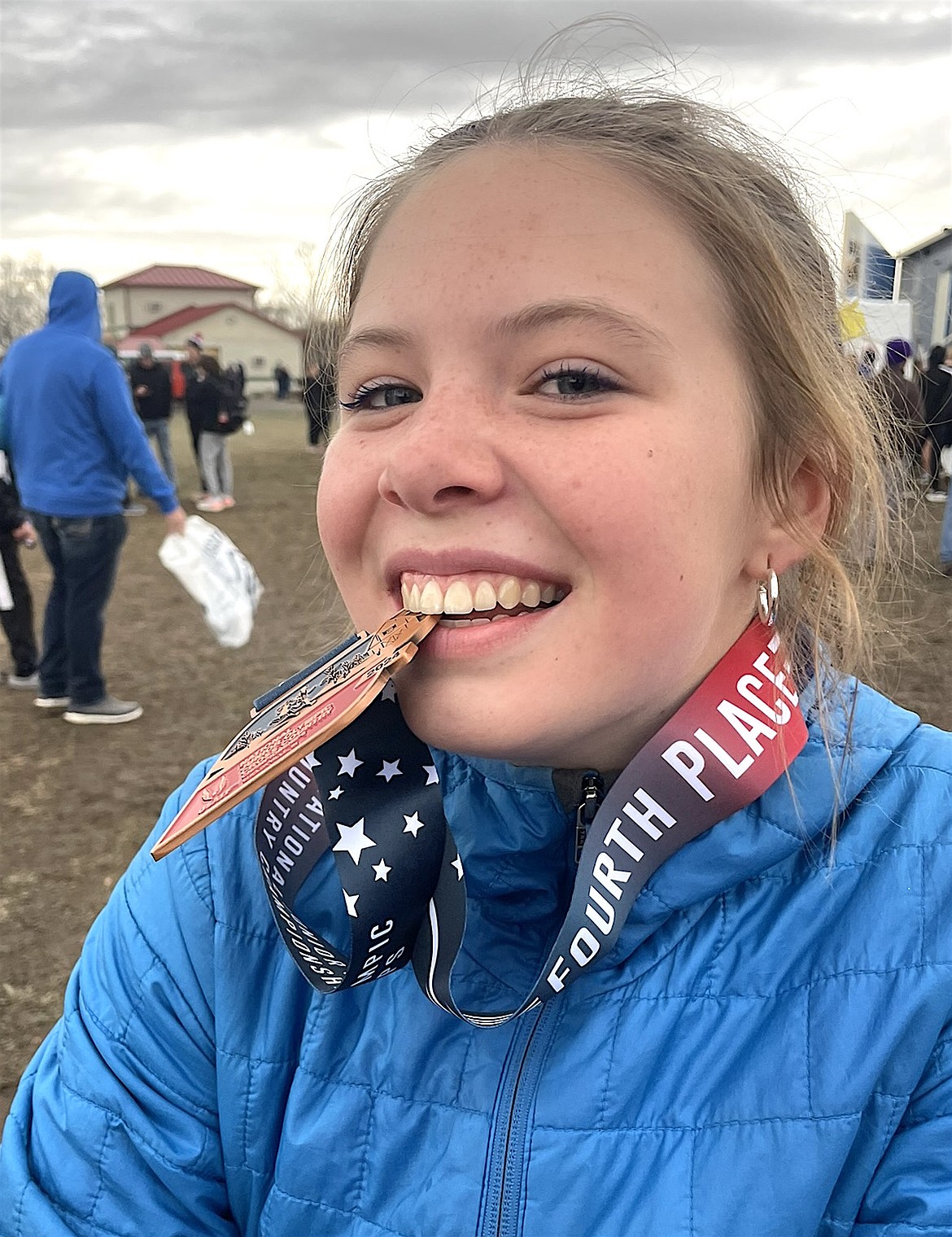 Polson runner Morgan Delaney shows off her fourth place medal, earned Dec. 14 at the USATF National Junior Olympics Championships in Indiana. (Courtesy photo)