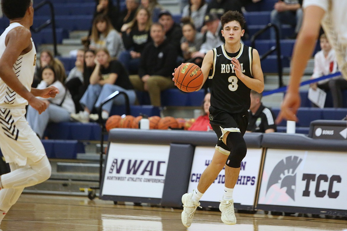 Royal senior Ezra Jenks (3) dribbles the ball up the floor against Annie Wright last season. Jenks led the Knights with 19 points in Saturday’s bracket championship game against The Ambrose School (Idaho).