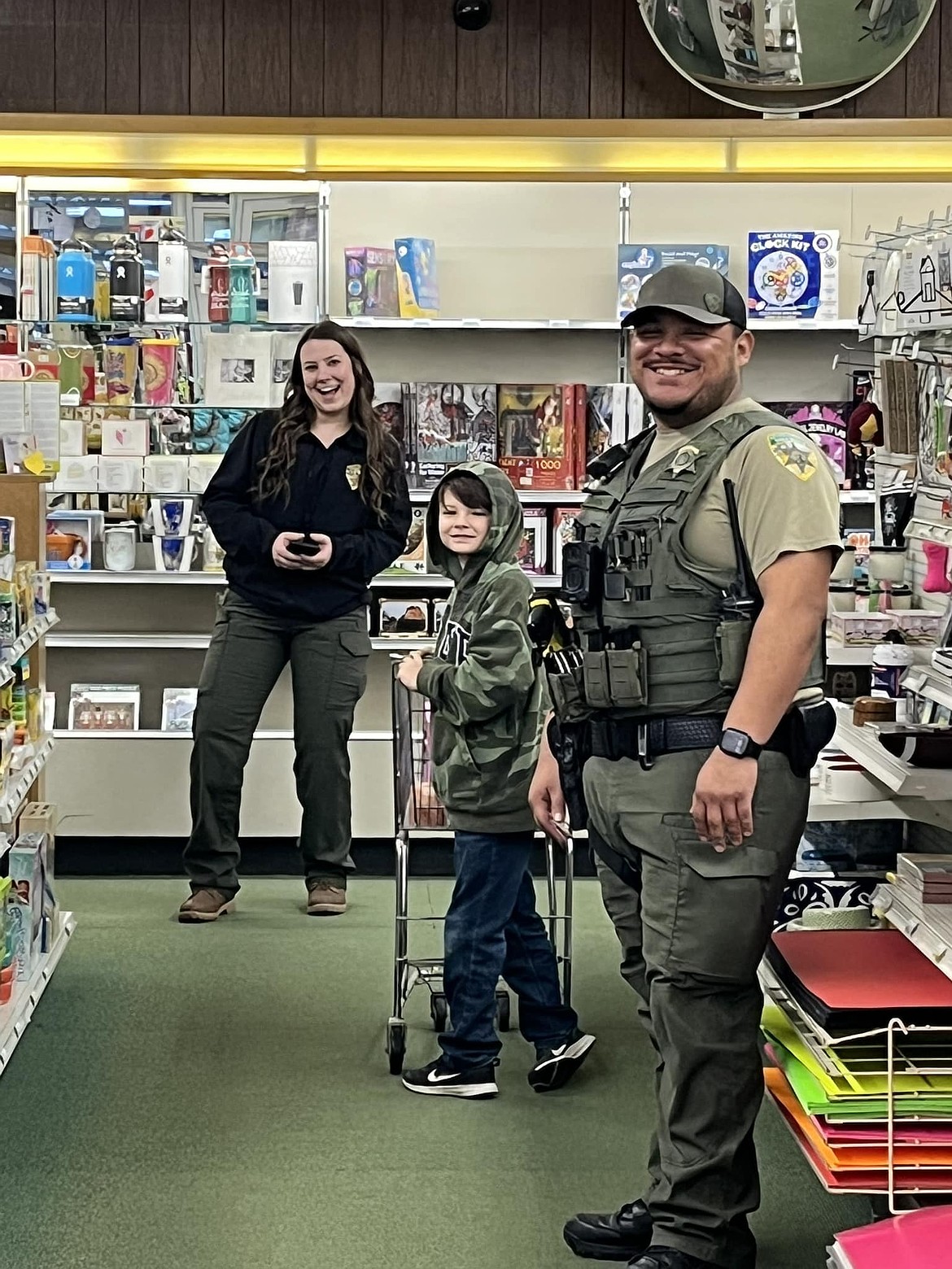 A shopper and shopping buddies peruse the selections during Saturday’s Shop with a Cop event in Ritzville.