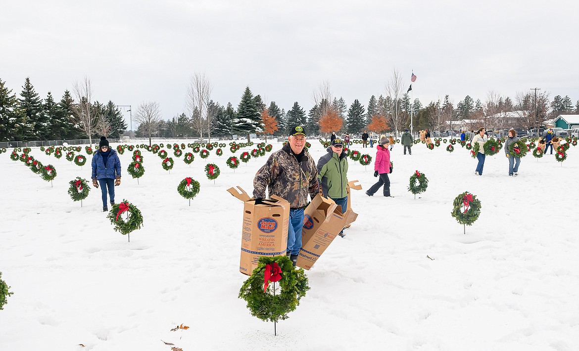 Jeff Harker was one of many that helped put out wreaths on graves at the Montana Veterans Home Cemetery Saturday for Wreaths Across America.