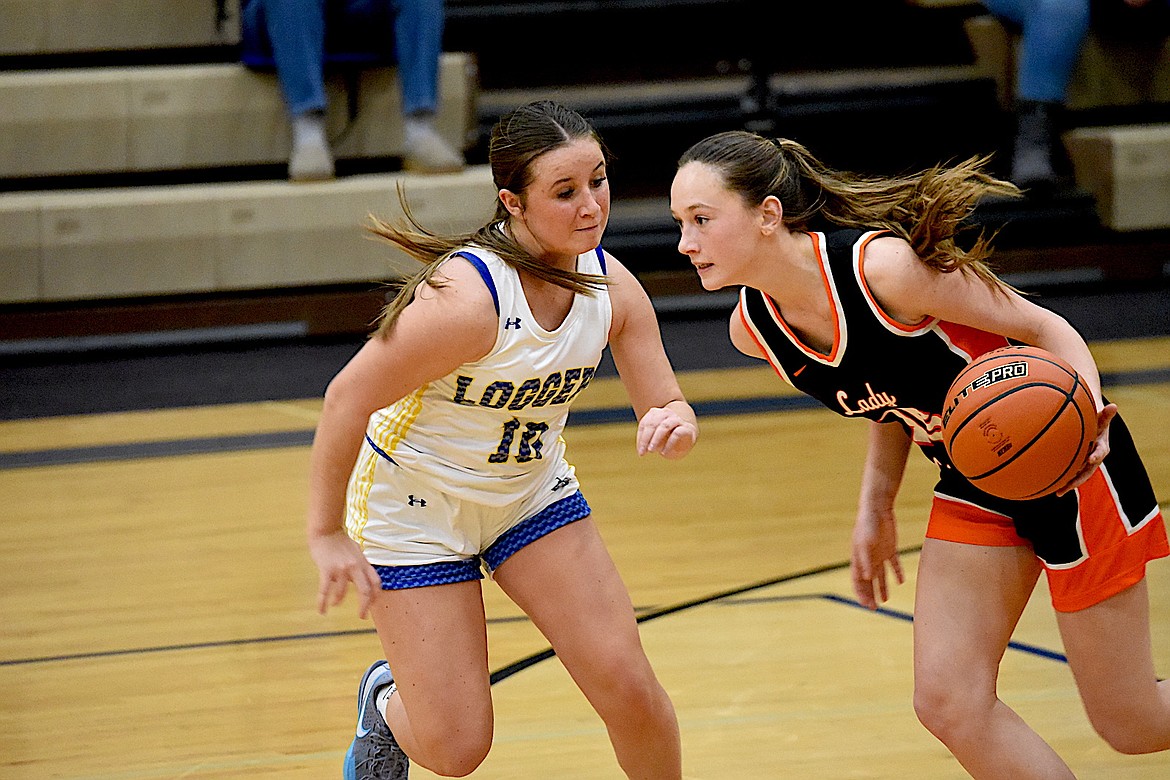 Libby's Maddy Vincent tries to slow down Eureka's Haidyn Guckenberg during their game in Libby Tuesday, Dec. 18, 2024. Guckenberg scored a team-high 15 points for the Lady Lions in a 46-38 win, securing the Battle of the Kootenai trophy. (Scott Shindledecker/The Western News)