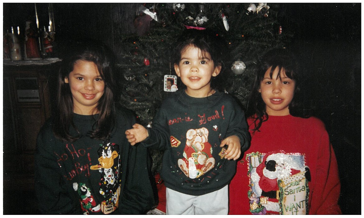 Press reporter Kaye Thornbrugh (center, age 3) celebrates Christmas with sisters Kelly and Kami in 1995.