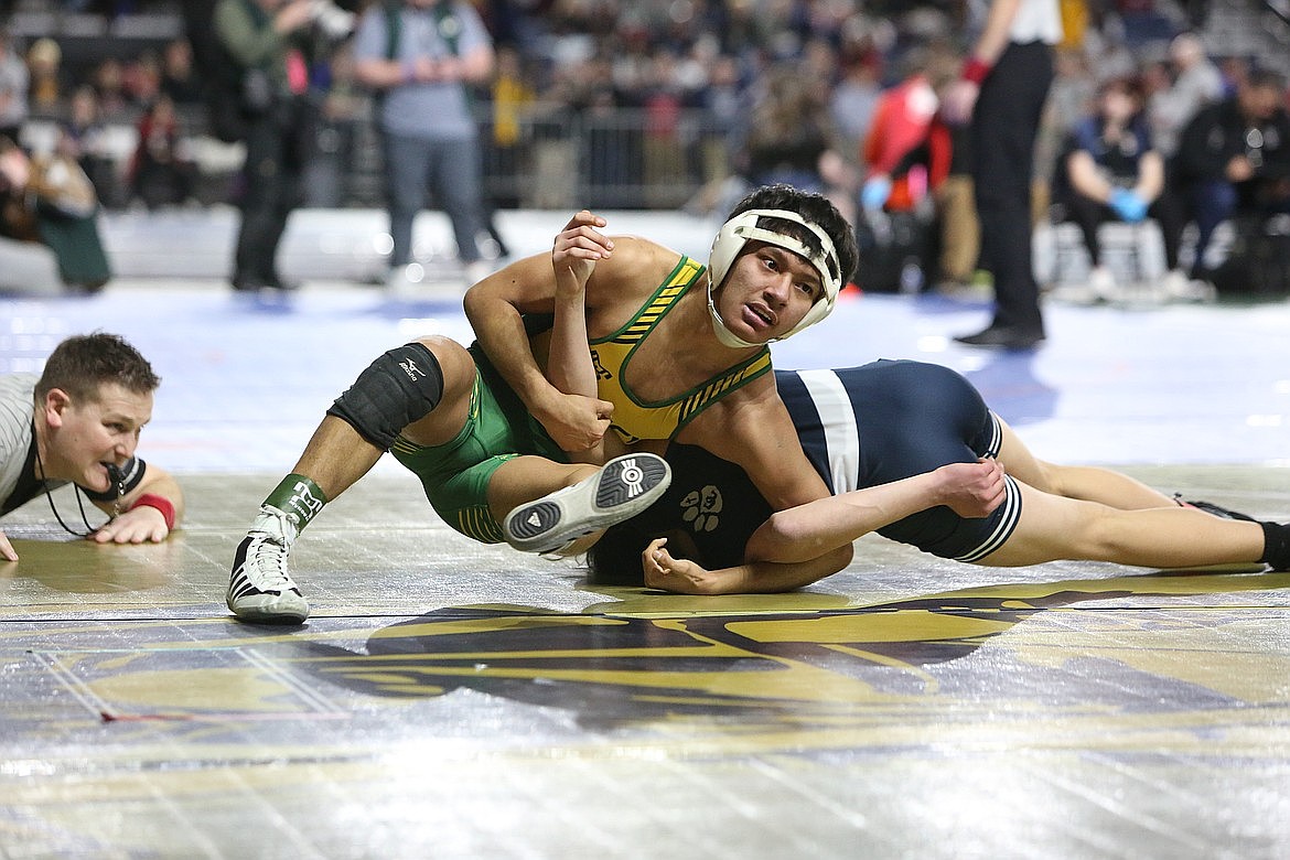 Quincy senior Saidt Alvarez, left, wrestles at the 2024 Mat Classic in Tacoma. Alvarez began Tuesday’s dual against Royal with a win against Royal junior Dennis Hernandez, in a matchup of placers from last year’s state tournament.