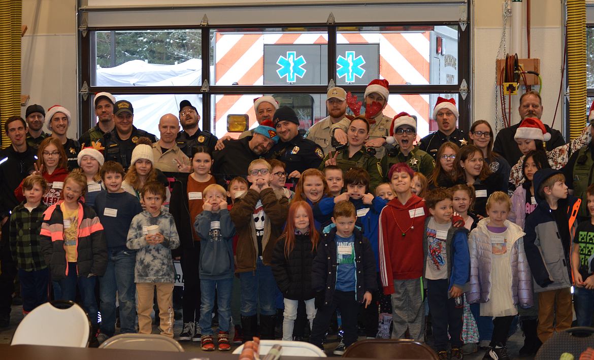 Lots of happy, smiling faces (kids and adults) following the Shop-With-A-Cop pizza party at Shoshone County Fire District #1 in Osburn.