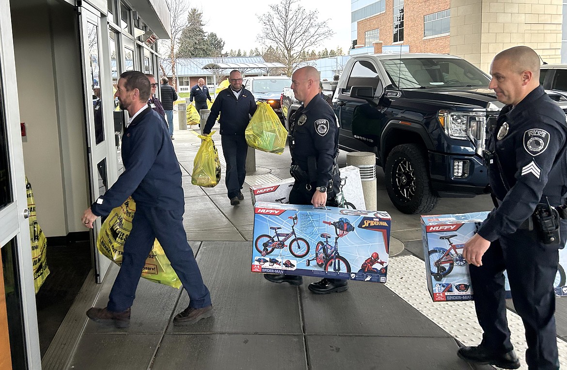 Coeur d'Alene police officers and Les Schwab Tire Center staff deliver toys and more to Kootenai Health on Thursday.