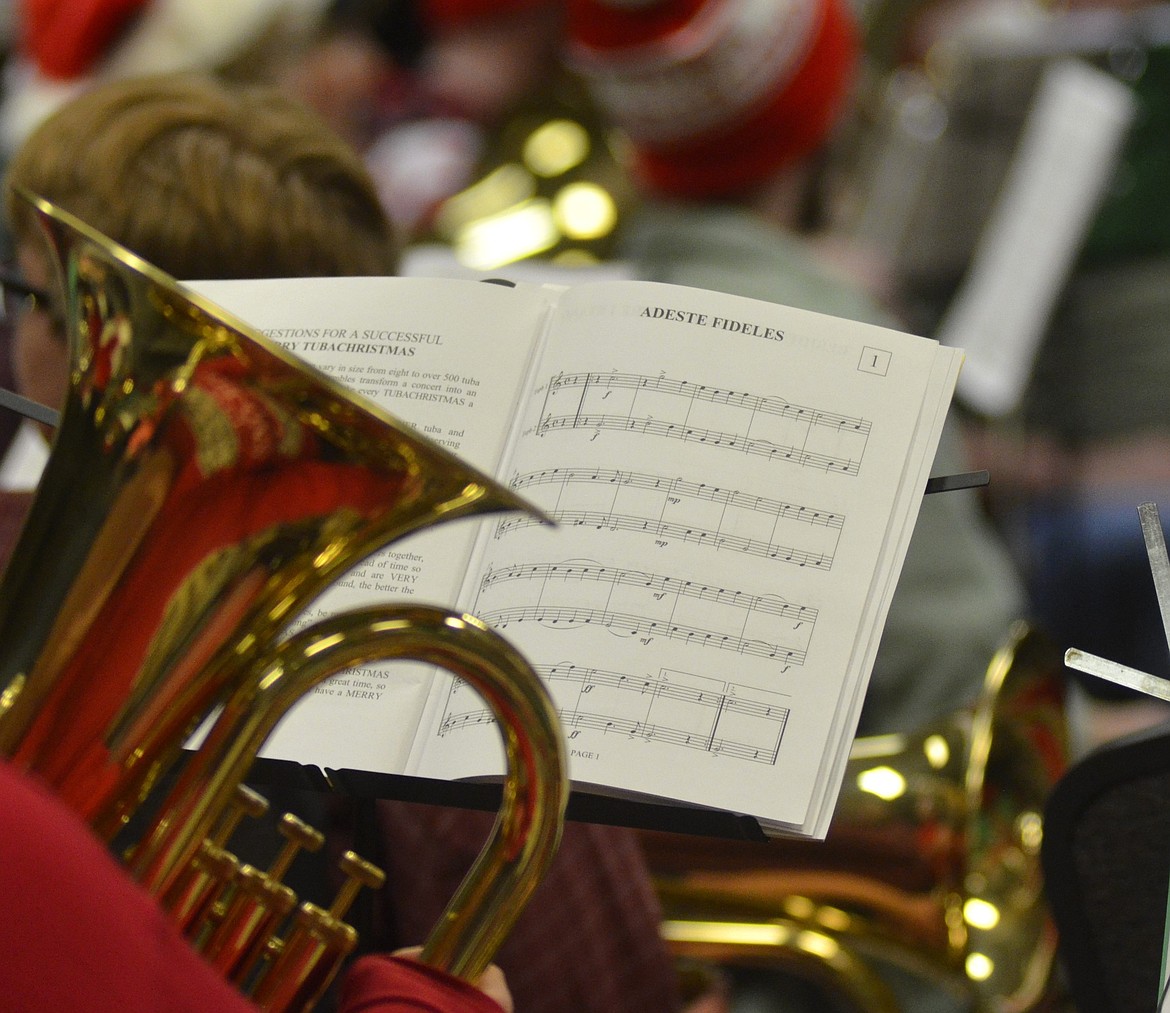 Music sits on a stand during the TubaChristmas concert on Dec. 16 at the Red Lion Hotel in Kalispell. The band plays familiar holiday tunes during the roughly one-hour concert. (Heidi Desch/Daily Inter Lake)