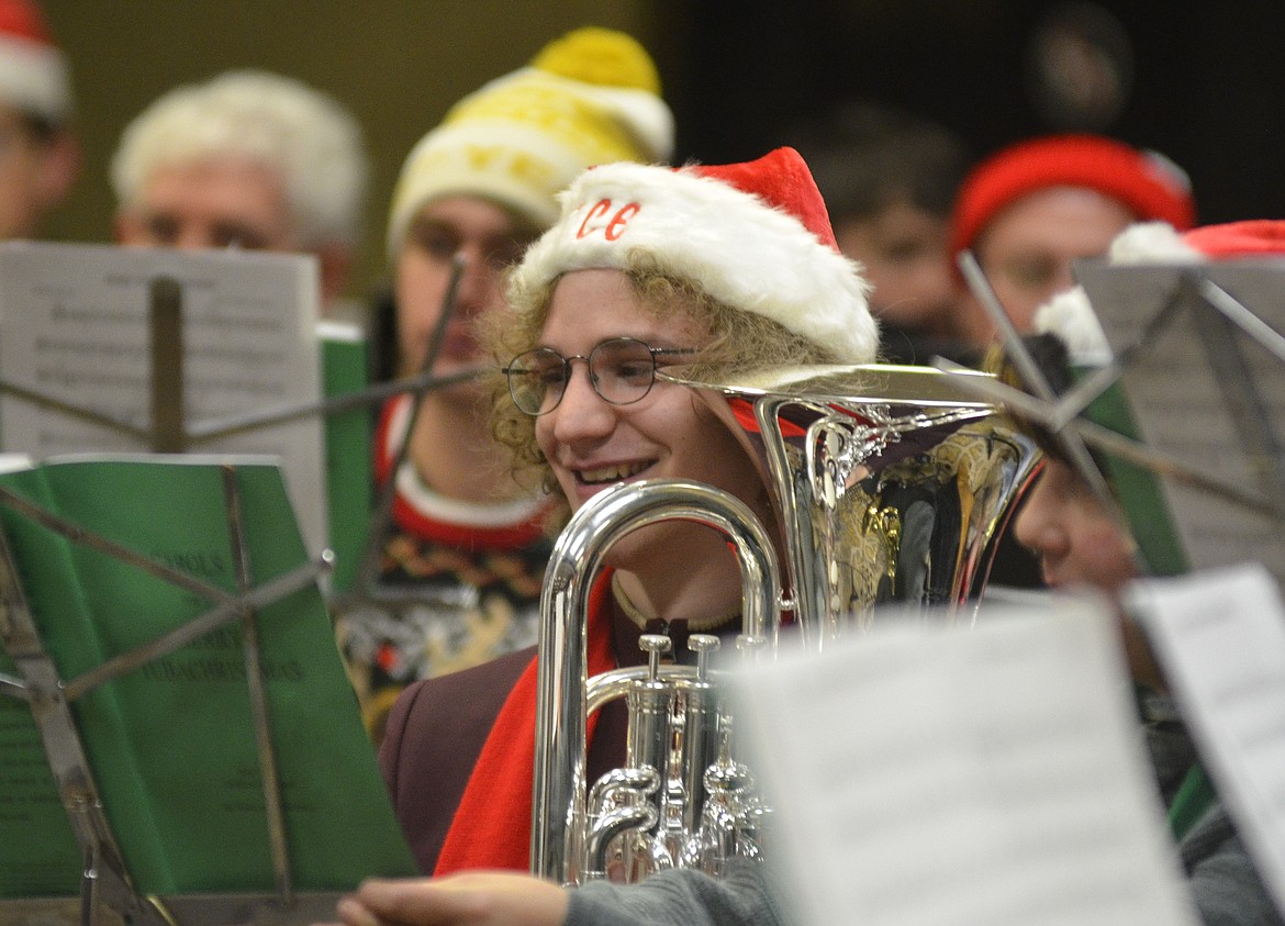 A musician smiles in between songs during the TubaChristmas concert on Dec. 16 at the Red Lion Hotel in Kalispell. (Heidi Desch/Daily Inter Lake)