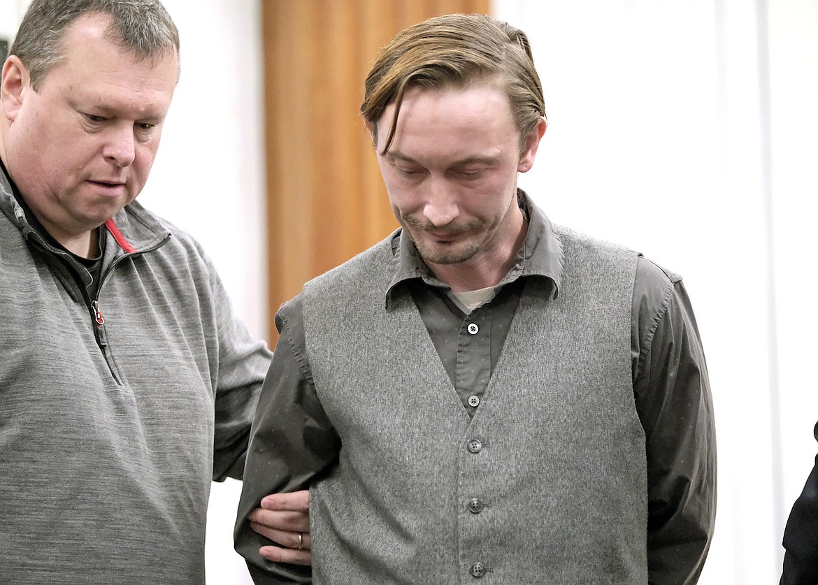 State probation officer Steve Watson, left, escorts Silas C. Behee from the courtroom in the Lincoln County Courthouse after sentencing Monday, Dec. 16, 2024. (Paul Sievers/The Western News)
