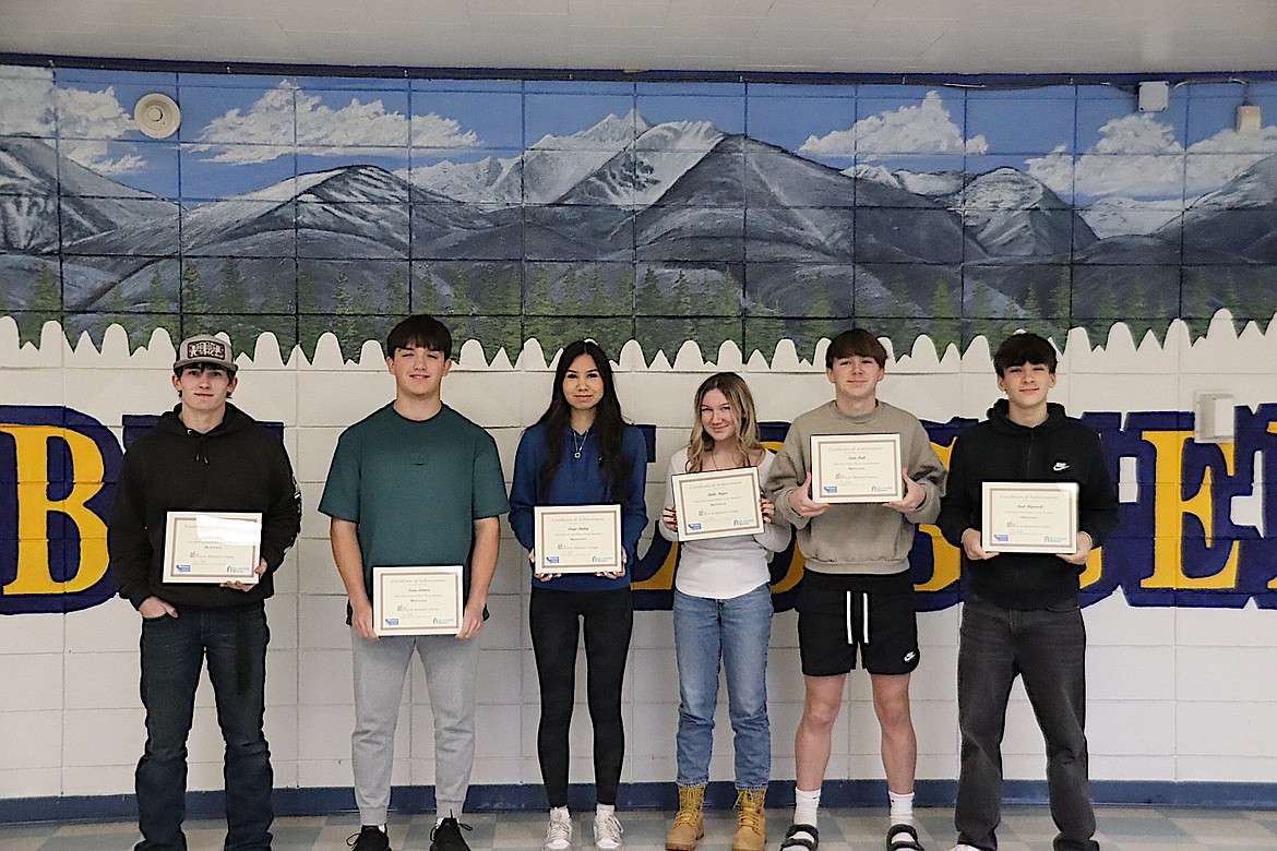 Libby High School students Connor Benson, Isaac Lamere, Paul Hipuesch, Kale Hall, Augie Bailey and Bella Meyer show off their awards after placing in the top four of the Montana Council for Economic Education Fall 2024 Stock Market Game. Nicole Nixon was not pictured. (Courtesy photo)