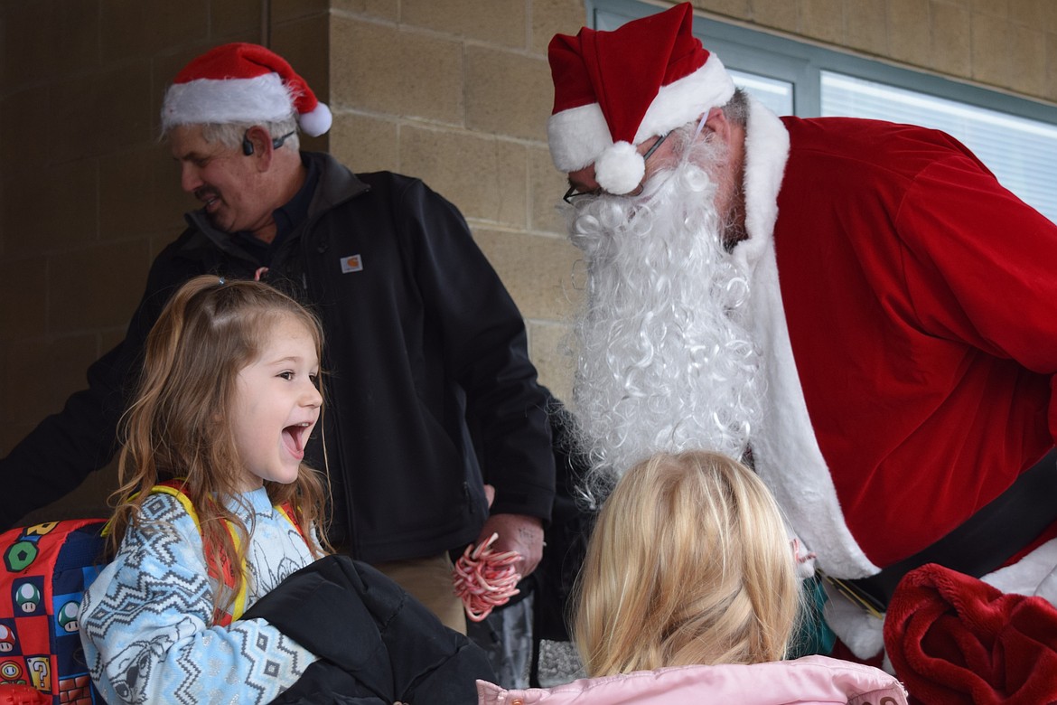 Ryder B. chats with Santa as Dalton Elementary School let out for its holiday break Friday.