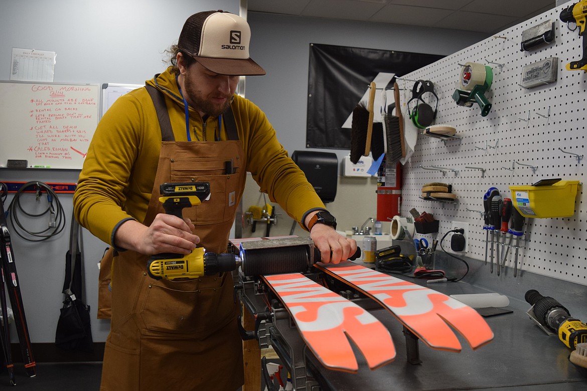 Shop manager Anthony Tutor works on a pair of skis at Sportsman and Ski Haus in Coeur d'Alene.