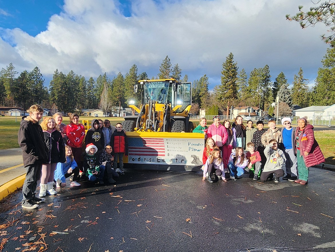 Ponderosa Elementary School students pose by the Post Falls snowplow they decorated with artwork.